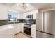 Updated kitchen features new stainless steel appliances, ample white cabinetry, and sleek countertops at 5011 Live Oak Cir # 65, Bradenton, FL 34207