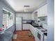 Classic kitchen with white cabinets, black countertop, white appliances, and wood-look flooring at 5011 Live Oak Cir # 65, Bradenton, FL 34207