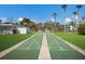 Outdoor shuffleboard courts with well-maintained green surfaces and clear markings, under a sunny sky at 5011 Live Oak Cir # 65, Bradenton, FL 34207