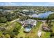 Aerial view of a charming waterfront property featuring a pool and lovely landscaping with canal access at 503 1St Nw Ave, Ruskin, FL 33570