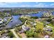 Scenic aerial view of waterfront homes and canals, surrounded by lush greenery and bright blue skies at 503 1St Nw Ave, Ruskin, FL 33570