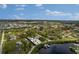 A beautiful waterfront home on a sunny day with a private dock, pool, and lush landscaping; enjoy the Florida lifestyle at 503 1St Nw Ave, Ruskin, FL 33570
