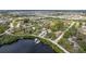 Expansive aerial shot of the community, highlighting the serene lake and a lovely home's prime location at 503 1St Nw Ave, Ruskin, FL 33570