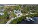 Stunning aerial view of a beautiful home with lush landscaping, a dock, and water access at 503 1St Nw Ave, Ruskin, FL 33570