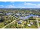 Overhead view of a waterfront home with a pool surrounded by lush greenery, docks, and canals at 503 1St Nw Ave, Ruskin, FL 33570