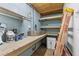 Functional basement featuring storage shelves, a workbench, and tool storage at 503 1St Nw Ave, Ruskin, FL 33570