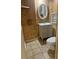 Bathroom featuring wood paneling, a vanity with a vessel sink, and neutral colored floors at 503 1St Nw Ave, Ruskin, FL 33570