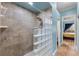 Walk-in shower with neutral-toned tiles and glass block divider near bedroom entry at 503 1St Nw Ave, Ruskin, FL 33570