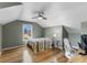 Cozy bedroom with a ceiling fan, a bed, and a window offering natural light and a view at 503 1St Nw Ave, Ruskin, FL 33570