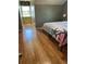 Bedroom featuring hardwood floors, a large window, and a bed with a decorative starfish cover at 503 1St Nw Ave, Ruskin, FL 33570
