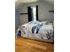 Bedroom featuring wood floors, a bed with a turtle comforter, and a large window with dark curtains at 503 1St Nw Ave, Ruskin, FL 33570