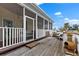 Spacious wooden deck featuring a railing, seating, and a view of the backyard at 503 1St Nw Ave, Ruskin, FL 33570