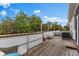 Outdoor wooden deck space with a grill, furniture, and a partial view of trees at 503 1St Nw Ave, Ruskin, FL 33570