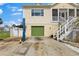 Spacious home featuring convenient garage access and staircase leading to a charming screened porch at 503 1St Nw Ave, Ruskin, FL 33570