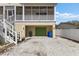 Charming exterior featuring stairs leading to the second level and a two-car garage below at 503 1St Nw Ave, Ruskin, FL 33570