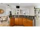 Open-concept kitchen featuring granite countertops, wood cabinets, and bar seating at 503 1St Nw Ave, Ruskin, FL 33570