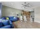 Inviting living room with a large blue sectional sofa and open access to a study area at 503 1St Nw Ave, Ruskin, FL 33570