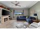 Cozy living room with a fireplace, built-in shelves, and a comfortable blue sectional sofa at 503 1St Nw Ave, Ruskin, FL 33570