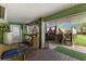Cozy covered outdoor area with a workshop, an open-air patio with a wooden deck, and an exterior door at 503 1St Nw Ave, Ruskin, FL 33570