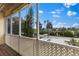 Covered porch with lattice railing, wooden floors and views of the boats, waterfront, and neighborhood at 503 1St Nw Ave, Ruskin, FL 33570