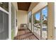 Exterior porch with a wooden bench and views of the waterfront and neighborhood street at 503 1St Nw Ave, Ruskin, FL 33570