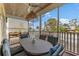Covered porch featuring a dining table with comfortable seating, lattice details, and a hanging light fixture at 503 1St Nw Ave, Ruskin, FL 33570
