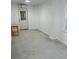 Bright, spacious room with light walls, concrete flooring, a door, and a wooden table at 503 1St Nw Ave, Ruskin, FL 33570