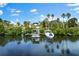 Picturesque waterfront property with a boat dock under a bright blue sky, perfect for boating enthusiasts at 503 1St Nw Ave, Ruskin, FL 33570