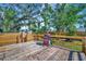 Wooden deck with a grill and a wooden fence offering views of the backyard and landscaping at 5061 Placida Rd # A, Englewood, FL 34224
