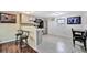Charming kitchen featuring gray cabinets, stainless steel appliances, and a cozy breakfast bar at 5061 Placida Rd # A, Englewood, FL 34224
