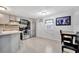 Updated kitchen featuring stainless steel appliances, gray cabinetry, tile floors, and breakfast table seating at 5061 Placida Rd # A, Englewood, FL 34224
