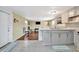 Open-concept kitchen with gray cabinets, breakfast bar, and seamless transition into the living area at 5061 Placida Rd # A, Englewood, FL 34224