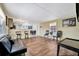 Open living room with kitchen bar, seating, wood floors, and dark colored leather couch at 5061 Placida Rd # A, Englewood, FL 34224