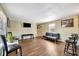 Bright living room with wood flooring, a mounted television, and ample seating at 5061 Placida Rd # A, Englewood, FL 34224