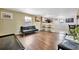 Open living room with wood floors and a view of the kitchen at 5061 Placida Rd # A, Englewood, FL 34224