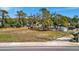 Cleared lot ready for your dream home with mature trees and wood and chain link fencing at 5061 Placida Rd # A, Englewood, FL 34224