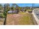 Cleared lot with mobile home, storage buildings, and wood and chain link fencing at 5061 Placida Rd # A, Englewood, FL 34224