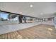 Bright sunroom with wood floors and large windows offering scenic views of the surrounding landscape at 5061 Placida Rd # A, Englewood, FL 34224