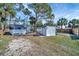 Yard featuring a storage building and mobile home with wood and chain link fencing at 5061 Placida Rd # A, Englewood, FL 34224
