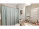 Bathroom featuring decorative shower curtain, granite vanity, and framed mirror for a polished look at 5068 Inshore Landing Dr, Apollo Beach, FL 33572