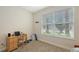 Bright bedroom featuring a large window with blinds, offering plenty of natural light and a desk at 5068 Inshore Landing Dr, Apollo Beach, FL 33572