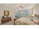 Comfortable bedroom featuring a ceiling fan, two windows, and sliding glass doors to screened patio at 5068 Inshore Landing Dr, Apollo Beach, FL 33572