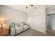 Guest bedroom featuring plush carpeting, warm lighting, and closet at 5068 Inshore Landing Dr, Apollo Beach, FL 33572