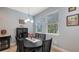 The dining area offers natural light, featuring a dark wood table set under modern pendant lighting at 5068 Inshore Landing Dr, Apollo Beach, FL 33572