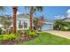 Charming single-story home featuring meticulous landscaping with lush greenery and decorative rock at 5068 Inshore Landing Dr, Apollo Beach, FL 33572