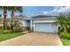 Charming single-story home featuring a spacious two-car garage and a beautiful, well-maintained lawn at 5068 Inshore Landing Dr, Apollo Beach, FL 33572