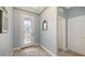 Bright foyer with decorative glass door, tile flooring, and high ceilings, creating an inviting entrance at 5068 Inshore Landing Dr, Apollo Beach, FL 33572