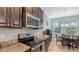 A functional kitchen is equipped with stainless steel appliances, granite countertops, and dark wood cabinets at 5068 Inshore Landing Dr, Apollo Beach, FL 33572