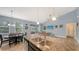 Large granite kitchen island featuring a double sink sits adjacent to the dining and Gathering rooms in this open floor plan at 5068 Inshore Landing Dr, Apollo Beach, FL 33572