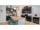A stylish kitchen showcases dark wood cabinets, granite counters, stainless steel appliances, and a functional center island at 5068 Inshore Landing Dr, Apollo Beach, FL 33572